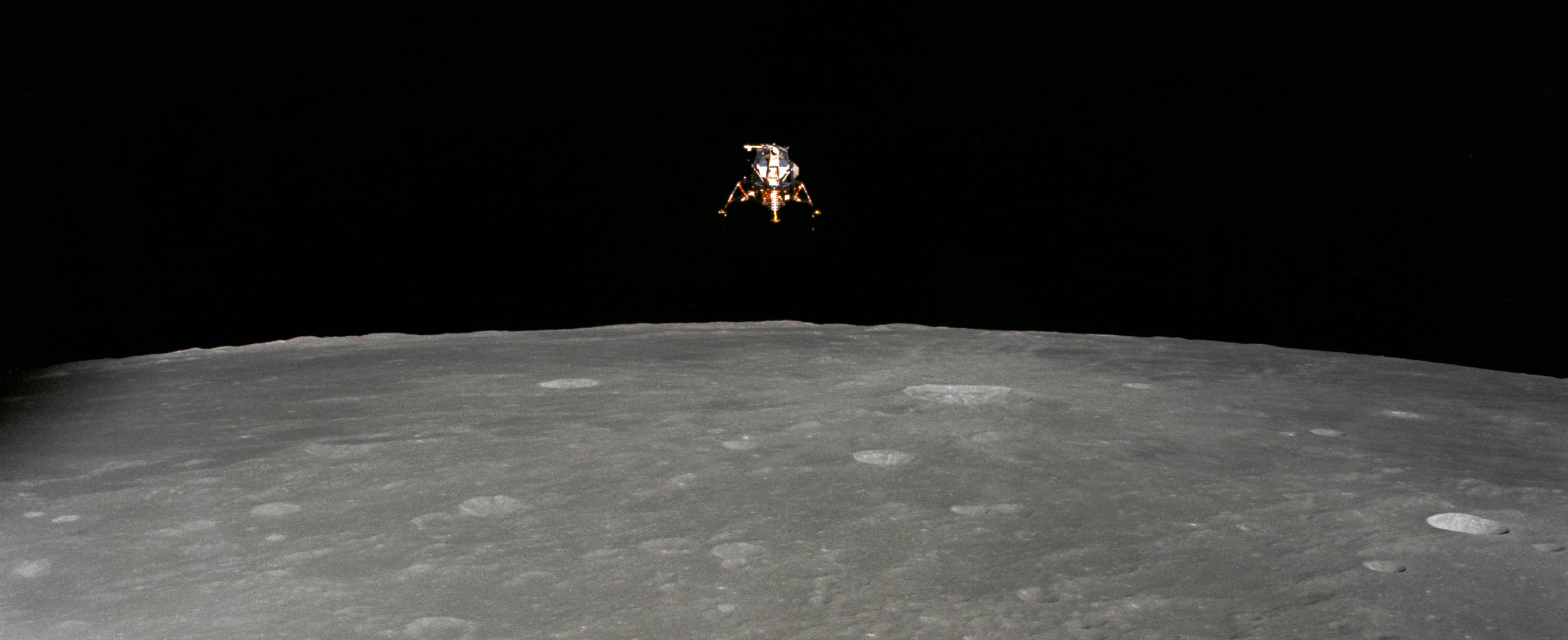 Lunar module hovering above the moon.