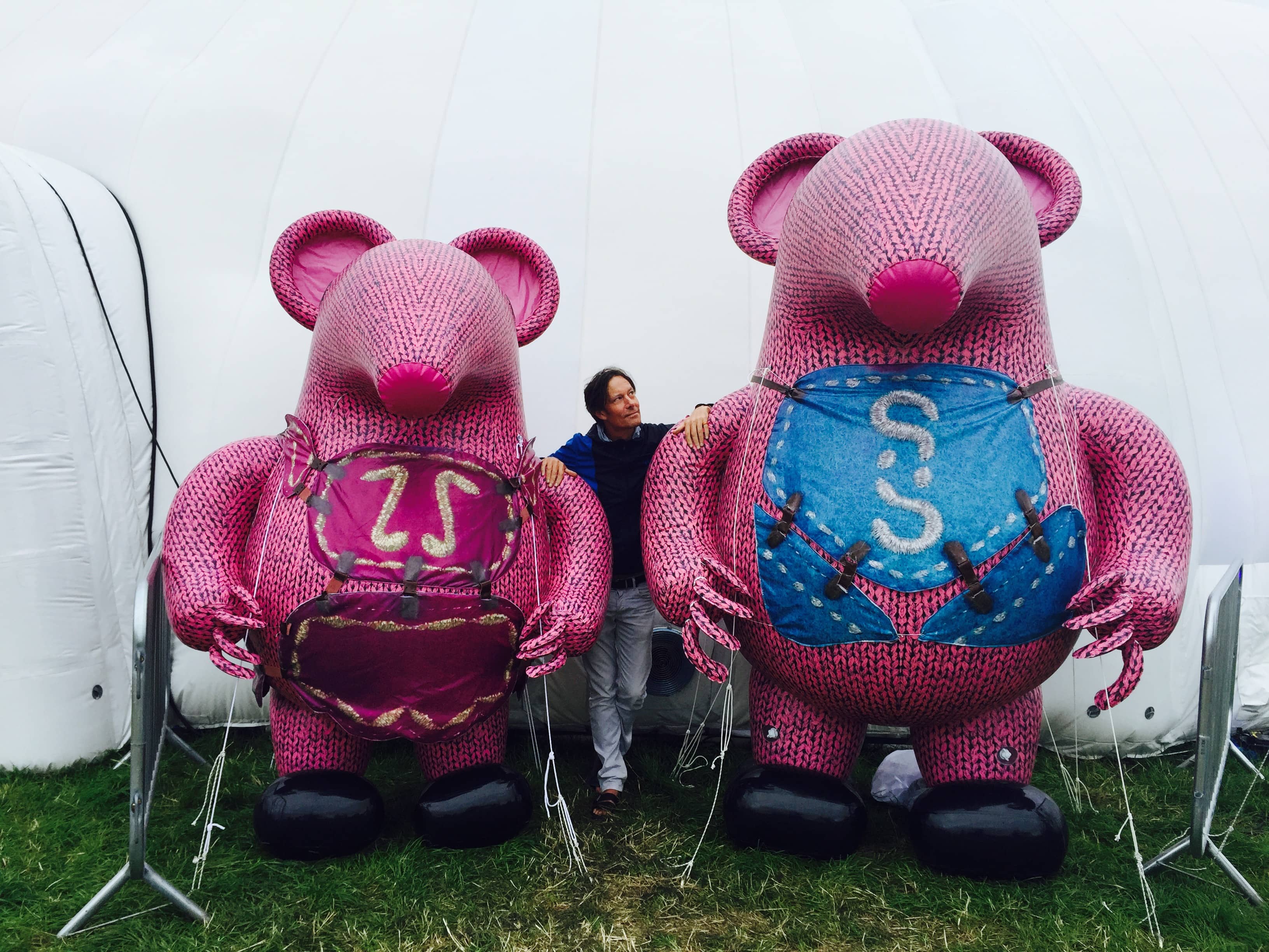 Andrew stood between two large pink mouse sculptures.